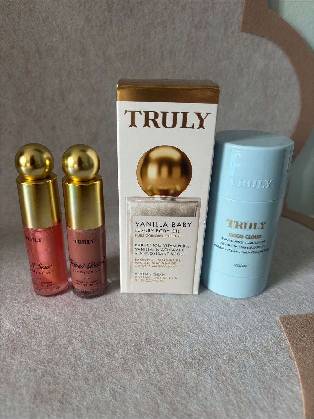 TRULY vanilla baby body oil and coco cloud deodorant, two lip oils